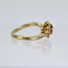 A wonderful cocktail ring by Kurt Wayne.  In 18K yellow gold with a half-twist to the shank. The shank supports a gallery with a central pear-cut ruby and 10 small round cut diamonds.   A high-level ring from the famous New York jewelry designer!  Marked to the shank 750 for 18k gold fineness and with a conjoined KW for Kurt Wayne.  Ring Size: ca. 5 1/2  Dimensions reference the ring size and are not specific to the ring itself. Gold Ruby Ring Pear-shaped, Yellow Gold Ruby Ring With Prong Setting, Formal Yellow Gold Ruby Ring With Single Cut Diamonds, Yellow Gold Pear-shaped Ruby Ring, Pear-shaped Ruby Ring With Diamond Halo Setting, Pear-shaped Ruby Ring With Diamond Halo, Pear-shaped Ruby Ring In Yellow Gold With Prong Setting, Pear-shaped Ruby Ring In Gold, Pear-shaped Brilliant Cut Yellow Gold Ruby Ring