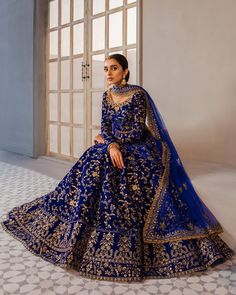 a woman in a blue and gold wedding gown