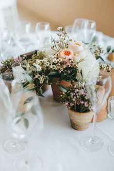 the table is set with flowers and wine glasses