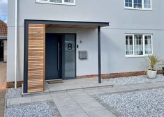 a grey house with a blue door and window