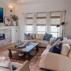 a living room filled with furniture and a flat screen tv mounted on the wall above a fireplace