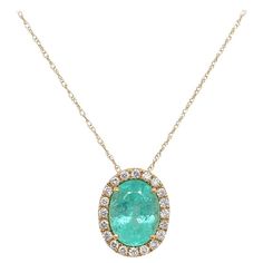 18K Yellow Gold Paraiba Tourmaline: 3.13ct total weight. Diamonds: 0.29ct total weight. All diamonds are G-H/SI stones. 18in Chain Elegant Tourmaline Yellow Gold Necklace, Luxury Yellow Gold Tourmaline Earrings, Yellow Gold Tourmaline Pendant Necklace, Yellow Gold Tourmaline Multi-stone Jewelry, Luxury Tourmaline Pendant Jewelry, Paraiba Tourmaline, Halo Setting, Yellow Gold Pendants, Gold Pendant Necklace