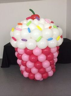 a bunch of balloons that are in the shape of a cupcake on a table