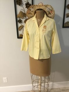 Classic vintage blouse would be adorable with a pair of capris or a mini.  Color is yellow and the embroidered rose is a cocoa brown.  Label reads "man tailored 100% cotton Made in USA".  Has just been washed and pressed and is ready to wear.  Coming to you from my personal collection.  Hat being sold separately. Measurements:  36" bust; 35" mid body; 34" hemline; 21 1/2" tall Thanks for stopping by my Etsy store! Cocoa Brown, Yellow Blouse, Blouse Vintage, Cotton Blouses, Vintage Shirts, Vintage Finds, Etsy Vintage, Womens Clothing Tops, Blouses For Women