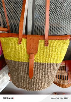 You don't have to be a millionaire to elevate your style and fashion, you need creativity and Arts. We African 1 Stores offers to you the most modern hand made tote bag woven 100% from sisal with Quality leather straps locally tunned from cows.  These beautiful handmade Tote bag originated from craftsmen living in Eastern Community in Kenya, the Akamba. Our Tote bags are woven using colored sisal and leather.The woven bag is made from products which are entirely eco-friendly and sustainable, leather to provide comfort and padding. Leathers are naturally tanned from cows. It has a zipper and an inner lining. This Tote bag is really stylish, functional and eco-friendly for everyday use, summer travels and beyond. From travel to work or a night out, makes it easier to fill your closet with et Eco-friendly Woven Straw Bag For Travel, Eco-friendly Weaved Straw Bag For Travel, Eco-friendly Woven Straw Travel Bag, Woven Top Handle Beach Bag For Shopping, Woven Top Handle Beach Bag, Eco-friendly Straw Travel Bag With Weaving, Handwoven Tote Bucket Bag, Travel Tote Straw Bag With Weaving, Eco-friendly Straw Bags With Weaving