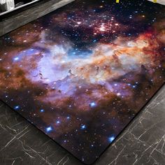 a large area rug with an image of the stars and galaxy in it on a floor