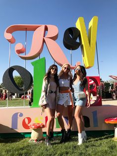 two women standing next to each other in front of a sign that says we love you