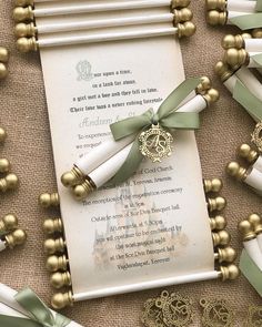 the wedding stationery is decorated with gold, green and white ribbons