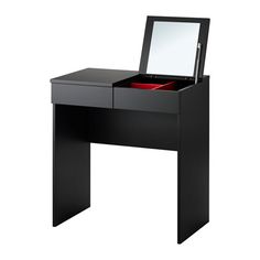 a black vanity table with a mirror and drawer on it's side, in front of a white background