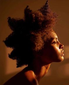 a close up of a person with an afro