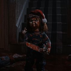 a creepy doll holding a chainsaw in the dark