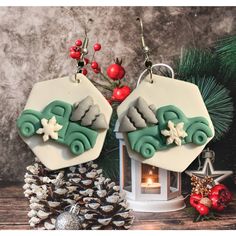 two decorated christmas ornaments sitting on top of a table