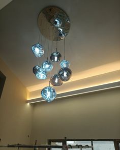 a chandelier hanging from the ceiling in a room with glass balls on it