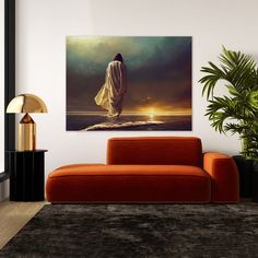 a living room with an orange couch and large painting on the wall above it's head