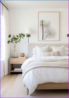 a bed with white linens and pillows in a bedroom next to a painting on the wall