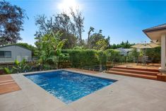 a backyard with a swimming pool and decking