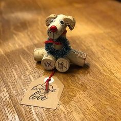 a wooden table with a wine cork dog on it's side and a price tag attached to it