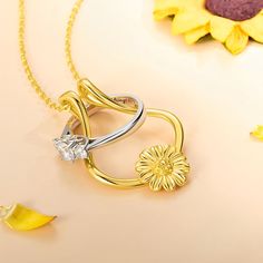 This is a beautiful and practical necklace that allows you to keep your ring safe and close to your heart. The sterling silver ring holder features a delicate sunflower design that symbolizes happiness, loyalty, and love. The necklace is perfect for anyone who needs to take off their ring for work, sports, or other activities, or who simply wants to wear their ring in a different way. The necklace comes with a  sterling silver chain and a lobster clasp. The ring holder can accommodate most ring Anniversary Gold Jewelry With Sunflower Design, Sunflower Design Jewelry For Anniversary, Sunflower Design Flower Jewelry For Anniversary, Wedding Jewelry With Sunflower Design, Sunflower Design Jewelry For Mother's Day Anniversary, Sunflower Jewelry For Anniversary And Mother's Day, Elegant Round Jewelry With Sunflower Design, Yellow Flower Shaped Jewelry For Anniversary, Yellow Flower-shaped Jewelry For Anniversary