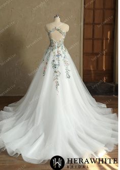 a white wedding dress with flowers on it