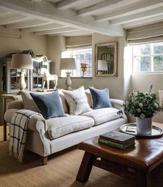 a living room filled with furniture and pillows