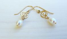 "Delicate dangle gold filled and pearls earrings. These romantic Boho earrings are made of high-quality 14K gold filled and have each a teardrop pearl hanging from a gold filled spiral. The dangling pearls and the spiral wire element give the earrings a romantic vintage look. The earrings are made from high quality 14K \"Gold Filled\" - unlike \"gold plating\" the gold in gold filled jewelry is mechanically bonded to the base metal, and it will not wear off or turn black These lovely earrings ar Delicate Gold Pearl Earrings Nickel Free, Dainty Handmade Gold Pearl Earrings, Dainty Gold Wire Wrapped Pearl Earrings, Earrings Gold Pearl, Drop Pearl Earrings, Chainmail Necklace, Pearl Earrings Gold, Dainty Gold Earrings, Bridal Earrings Pearl