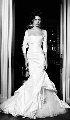 a black and white photo of a woman in a wedding dress