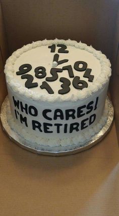 a white cake with black numbers on it sitting in a cardboard box, ready to be eaten