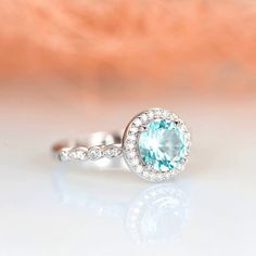 Gorgeous vintage inspired aquamarine ring is made of 925 solid sterling silver, making a simple but elegant statement piece. This ring is perfect to wear as engagement ring, promise ring, birthstone ring, or statement ring. Hypoallergenic, lightweight and minimalist. Main Stone: Aquamarine Shape: Round Gem size: 7.0 x 7.0 mm Carat Weight: 1.5 ct. Stone Creation: Lab-Created ►This ring can be paired with one or two matching milgrain style bands (select desired option from the drop-down menu). ►We Anniversary Halo Birthstone Ring With Round Band, Wedding Diamond Ring With Aquamarine Halo Setting, Aquamarine Wedding Diamond Ring With Halo Setting, Round Aquamarine Wedding Ring, Anniversary Birthstone Ring With Halo Setting And Round Cut, Anniversary Birthstone Ring With Halo Setting, Anniversary Birthstone Ring With Halo Design, Aquamarine Diamond Promise Ring, Round Aquamarine Diamond Ring For Wedding