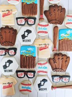 decorated cookies are arranged in the shape of baseballs and mitts with sunglasses on them