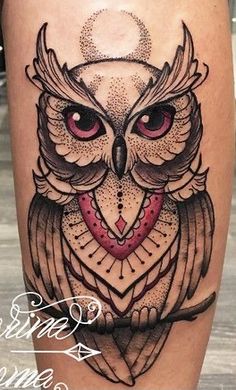 an owl tattoo is shown on the leg