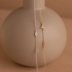 Add a touch of personal elegance to your attire with our Sideways Initial Heart Necklace, a beautifully designed piece that blends a heart-shaped pendant with your chosen initial. Crafted with precision and attention to detail, it's a versatile accessory that symbolizes love and individuality ♡ Material: High Quality Solid 925 Sterling Silver Finish: Sterling Silver ∙ 18K Gold ∙ Rose Gold Dimension: 7mm letter height Design will come in all capital letters unless specified otherwise Size: The to Elegant Silver Heart Pendant Initial Necklace, Silver Heart Pendant Initial Necklace, Heart Initial Pendant Necklace With Adjustable Chain For Gift, Gift Heart Necklace With Initial Pendant And Adjustable Chain, Elegant Heart Pendant Initial Necklace For Her, Elegant Heart Pendant Initial Necklace For Mother's Day, Silver Heart Initial Necklace For Valentine's Day, Mother's Day Heart Necklace With Adjustable Initial Pendant, Elegant Heart Shaped Initial Necklace For Her