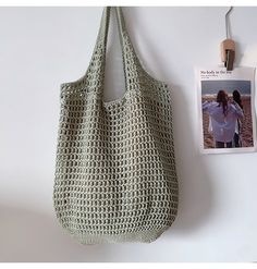 there is a bag hanging on the wall next to a magazine and an advertise