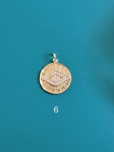 Spiritual Coin Charm Jewelry, Spiritual Coin Charms Jewelry, Spiritual Coin-shaped Charms Jewelry, Symbolic Round Evil Eye Jewelry, Gold Evil Eye Pendant Charm Necklace, Gold Evil Eye Round Jewelry, Gold Round Evil Eye Jewelry, Symbolic Gold Plated Coin Jewelry, Gold Evil Eye Pendant Jewelry