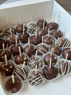 there are many chocolates in the box and on the stick with toothpicks