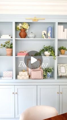 a room filled with lots of furniture and flowers on top of it's shelves