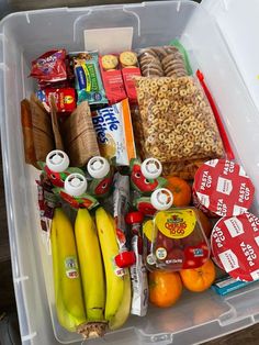 a plastic container filled with lots of different types of food and snacks on top of it