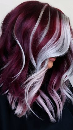 Embrace your fierce side with this fabulous hair transformation! The blend of vibrant burgundy and cool silver highlights creates a unique and eye-catching look. This hairstyle is perfect for anyone looking to express their individuality with style. #hairstyle #haircolor #haircut #wavyhair #hairinspo #burgundy Burgundy Hair Color With Blonde Highlights, Red Silver Hair Color, Silver To Red Ombre Hair, Platinum And Burgundy Hair, Blonde And Maroon Hair Highlights, Silver And Teal Hair, Silver Streak Hair, Money Piece Ombre, Blond And Burgundy Hair