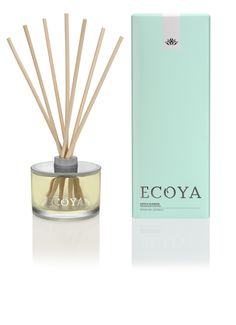 an ecoya reed diffuser next to a pink box