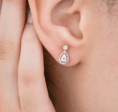 "Pear Cut Diamond Halo Stud Earrings For Her / Natural Diamond 14K Rose Gold Earrings / Modern Minimalist Earrings / Dainty Gold Earrings / Engage Jewelry / Engage Wedding Bridal Earrings ╰►Specifications ➤ Made to Order.  ➤ Made in Turkey. ➤ 14K Rose Gold ➤ Custom Gold Color: Rose Gold, Yellow Gold, White Gold ➤ Total CTW: 0.62 Carats ➤ Setting Type: Halo ➤ Natural Earth-Mined & Non-Conflict Diamonds ➤ Ready to Ship in 1 Week ╰► Center Stone Specifications ➤ Natural Diamond ➤ Shape: Pear Cut Diamonds ➤ Weight: 0.40 Carat (0.20 Carat Each) ➤ Color: G ➤ Clarity: SI1 ➤ Dimensions: Approx. 6x4MM ╰► Side Stone Specifications ➤ Natural Diamonds ➤ Round Cut Diamonds: 30 pieces of 1.00MM ➤ Round Cut Diamonds: 2 pieces of 2.10MM ➤ Carat Weight: 0.22 Carat of Round Cut Diamonds ➤ Color: G ➤ Clarity Dainty Gold Earrings, Halo Stud Earrings, Pear Cut Diamond, Halo Earrings Studs, Plain Bands, Earrings Dainty, Natural Earth, Modern Earrings, Diamond Halo