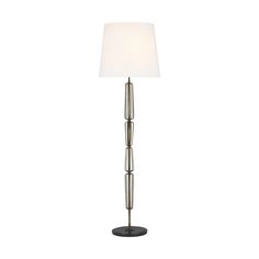 a floor lamp with a white shade on the top and bottom part of it's base