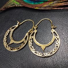 Small Ethnic Hoop Earrings in Silver or Gold Brass. These Creoles Are Openwork And Very Light. Sleek Style but the Circle is Decorated with Dots and Swirls Patterns to Give a More Bohemian Style but these Rings will complement all Styles. These Hoop Earrings are very elegant and they will illuminate your face. They are made from brass. Wear it everyday or whatever the occasion. Indispensable for Boosting an Allure, they Catch the Eye, Reflect the Light and Highlight the Face. Material: Brass Color: Silver or Gold Length: 3.2cm Width: 2.5cm Thickness: 0.2cm Handmade Delivered in a Fabric Pouch Ideal for Gifting To offer or simply treat yourself, do not hesitate! You Can Match Them With This Necklace: https://www.etsy.com/fr/listing/1230745378/collier-boheme-chic-pendant-silver-oo?ref=listin Bohemian Crescent Hoop Earrings With Ear Wire, Bohemian Teardrop Brass Hoop Earrings, Ornate Handmade Brass Hoop Earrings, Bohemian Crescent Hoop Earrings Nickel Free, Traditional Gold Nickel-free Hoop Earrings, Traditional Gold Hoop Earrings Nickel Free, Traditional Adjustable Small Hoop Jewelry, Ornate Chandbali Earrings For Festival, Traditional Small Hoop Nickel-free Earrings