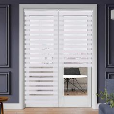 a living room with grey walls and white blinds