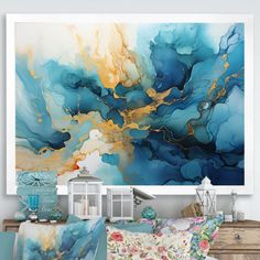 an abstract painting hangs on the wall above a bed with pillows and throw pillows in front of it