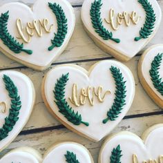 decorated cookies arranged in the shape of heart and wreaths with words love on them