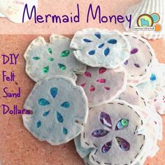 the mermaid money is made out of felt and sand dollar dollars are sitting on top of each other