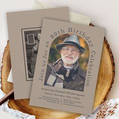 an old man wearing a hat and glasses on top of a birthday card next to a piece of wood