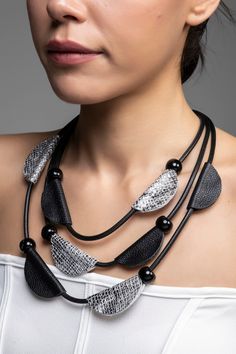 This handmade necklace is crafted using genuine leather and features an elegant design. Its adjustable feature allows it to fit different sizes. Ideal for women's daily wear, this necklace combines style and natural beauty. It can be a great gift option for yourself or your loved ones. Handmade Black Leather Jewelry, Leather Necklace For Gifting, Black Jewelry With Adjustable Length For Everyday, Chic Black Leather Jewelry, Handmade Black Leather Necklace, Elegant Jewelry With Adjustable Leather Strap, Elegant Black Necklace With Adjustable Cord, Adjustable Leather Necklace, Adjustable Leather Jewelry