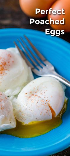 two eggs are on a blue plate with a fork and an egg in the background