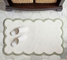 two pairs of slippers sitting on top of a rug