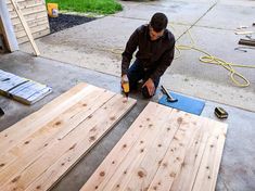 a man is working on some wooden boards